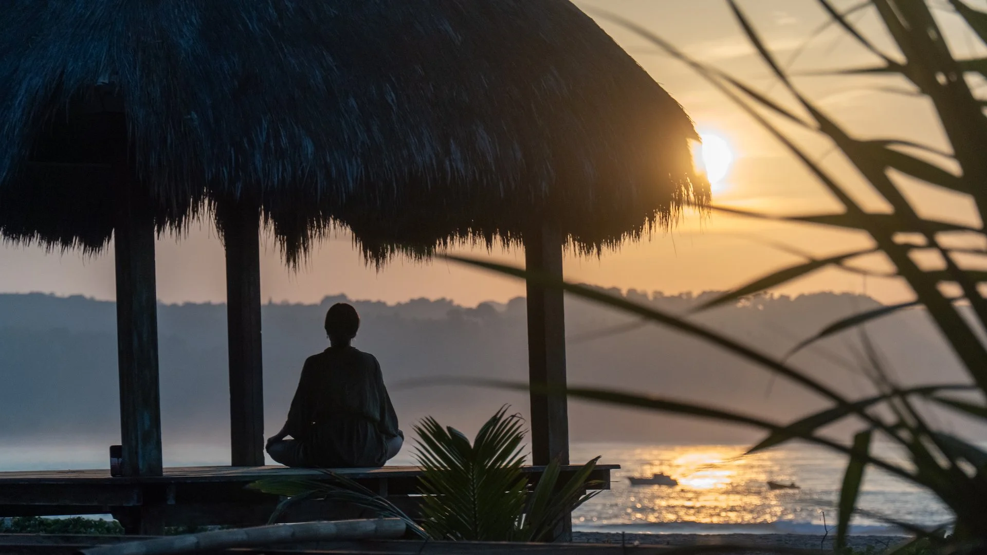 Open-air wellness bale at sunset