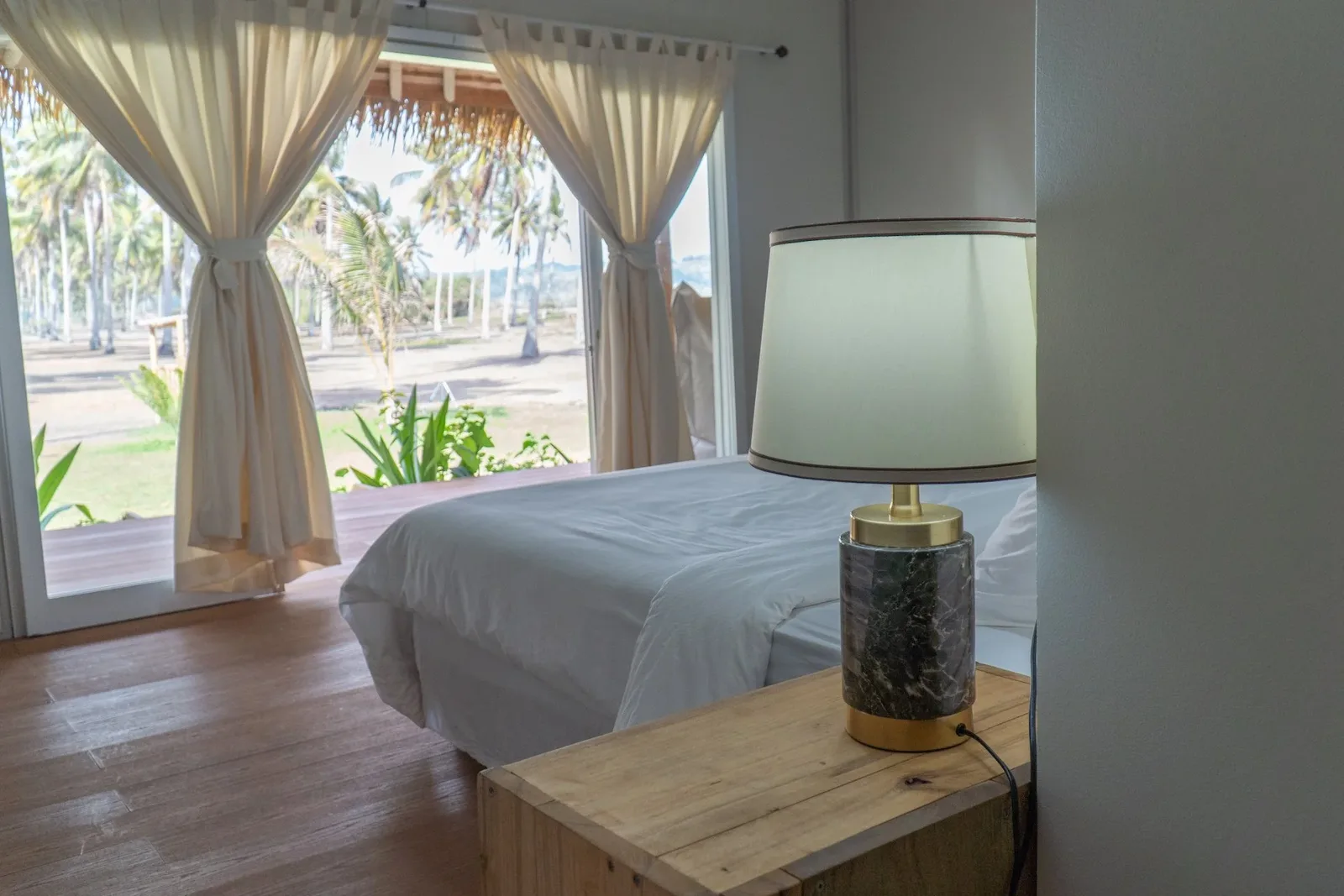 Villa Empat bedroom opening to the palms and ocean
