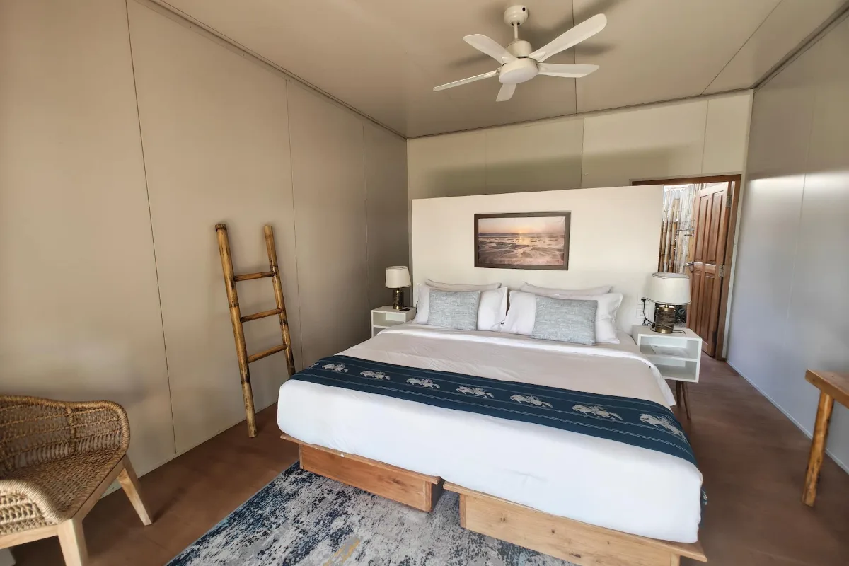 Villa Lima bedroom, king bed and rattan chair