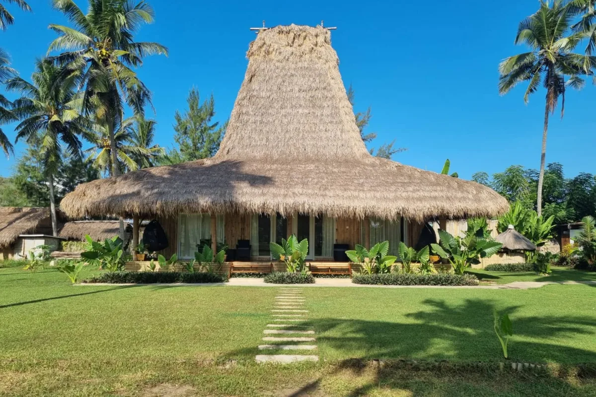 Villa Satu, peaked roof bungalow on the lawn among the palms