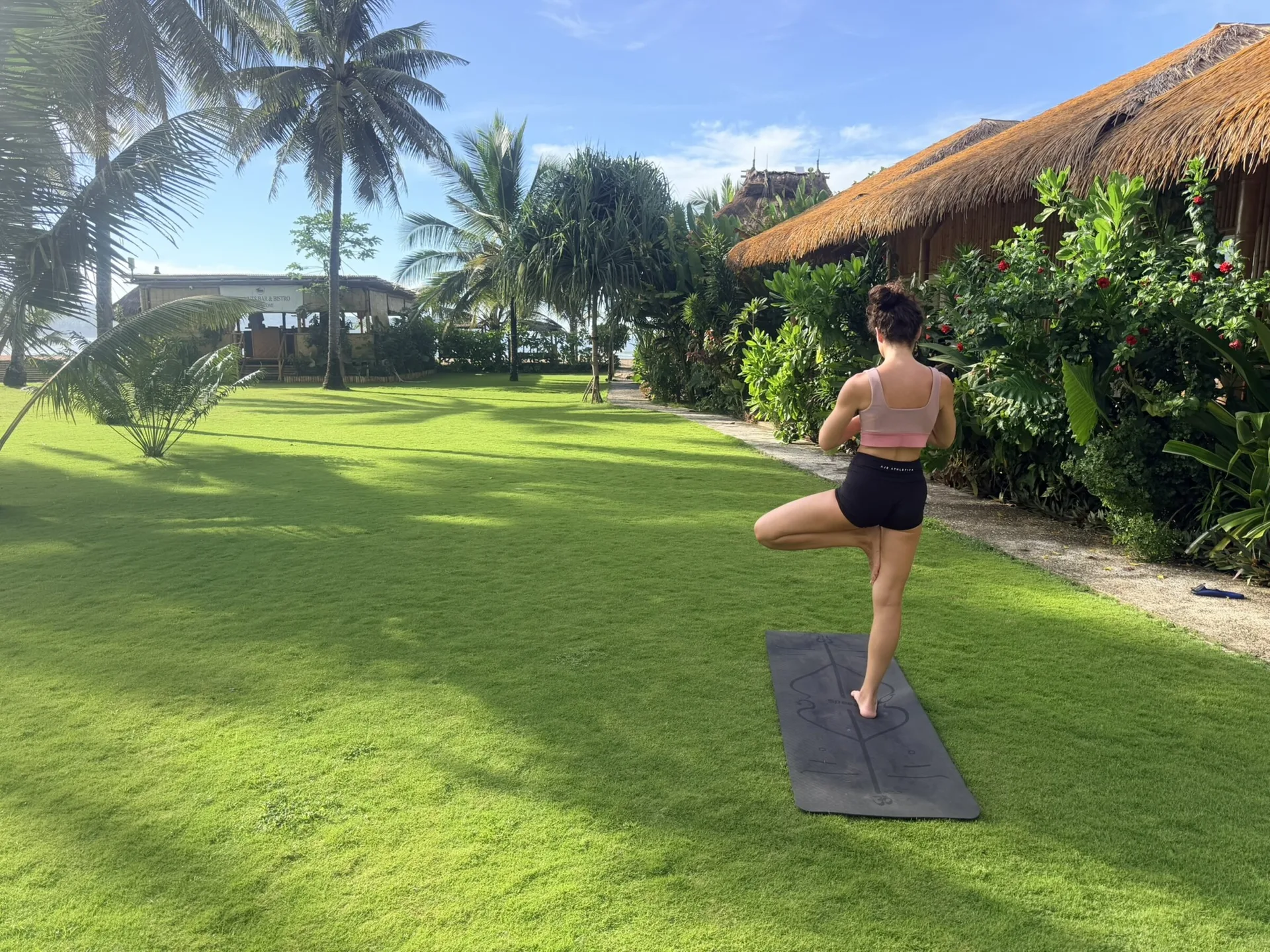 Yoga on the lawn among the palms